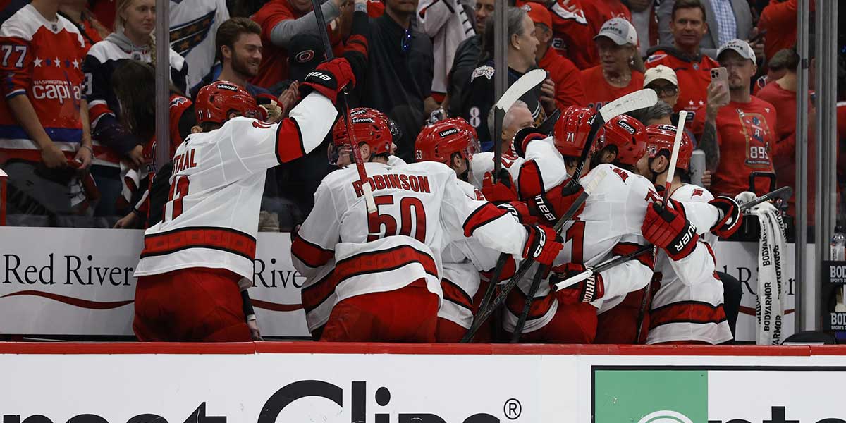 Carolina Hurricanes players celebrate on the bench after a go ahead goal by Hurricanes right wing Andrei Svechnikov (not pictured) against the Washington Capitals late in the third period in game five of the second round of the 2025 Stanley Cup Playoffs at Capital One Arena.
