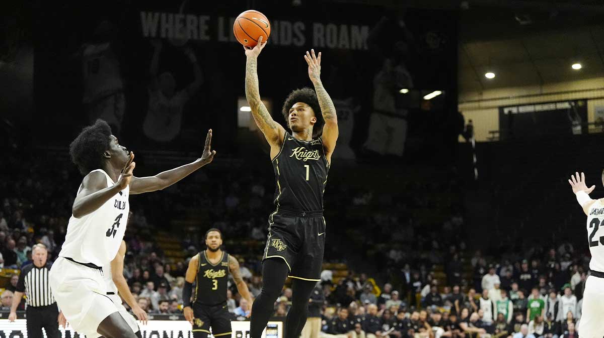 UCF Knights guard Mikey Williams (1) shoots the ball over Colorado Buffaloes forward Assane Diop (35) in the first half at the CU Events Center.
