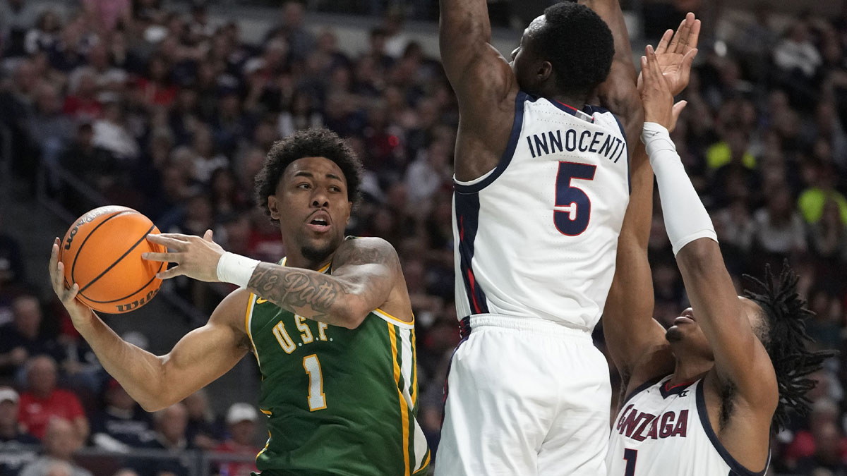 San Francisco Dons guard Malik Thomas (1) is defended by Gonzaga Bulldogs forward Emmanuel Innocenti (5) and guard Michael Ajayi (1) during the second half in the semifinal of the West Coast Conference tournament at Orleans Arena.