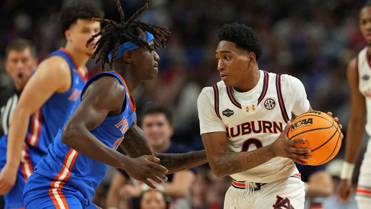 Auburn Tigers guard Tahaad Pettiford (0) controls the ball against Florida Gatorsguard Denzel Aberdeen (11) during the second half in the semifinals of the men's Final Four of the 2025 NCAA Tournament at the Alamodome.