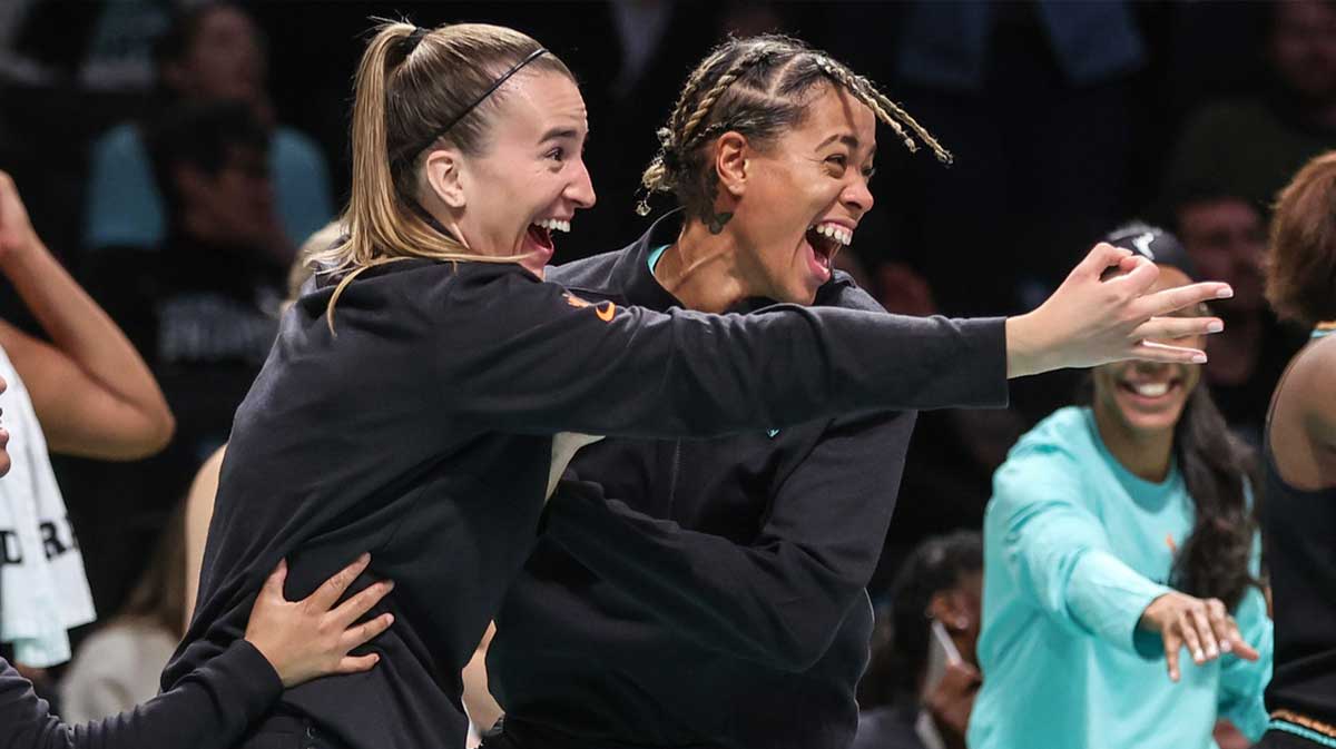 New York Liberty guards Sabrina Ionescu (20) and Natasha Cloud (9) celebrate from the bench in the fourth quarter against the Connecticut Sun at Barclays Center.