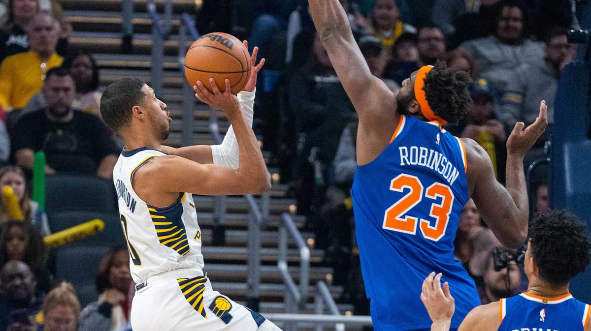Indiana Pacers guard Tyrese Haliburton (0) shoots the ball while New York Knicks center Mitchell Robinson (23) defends in the first quarter at Gainbridge Fieldhouse.
