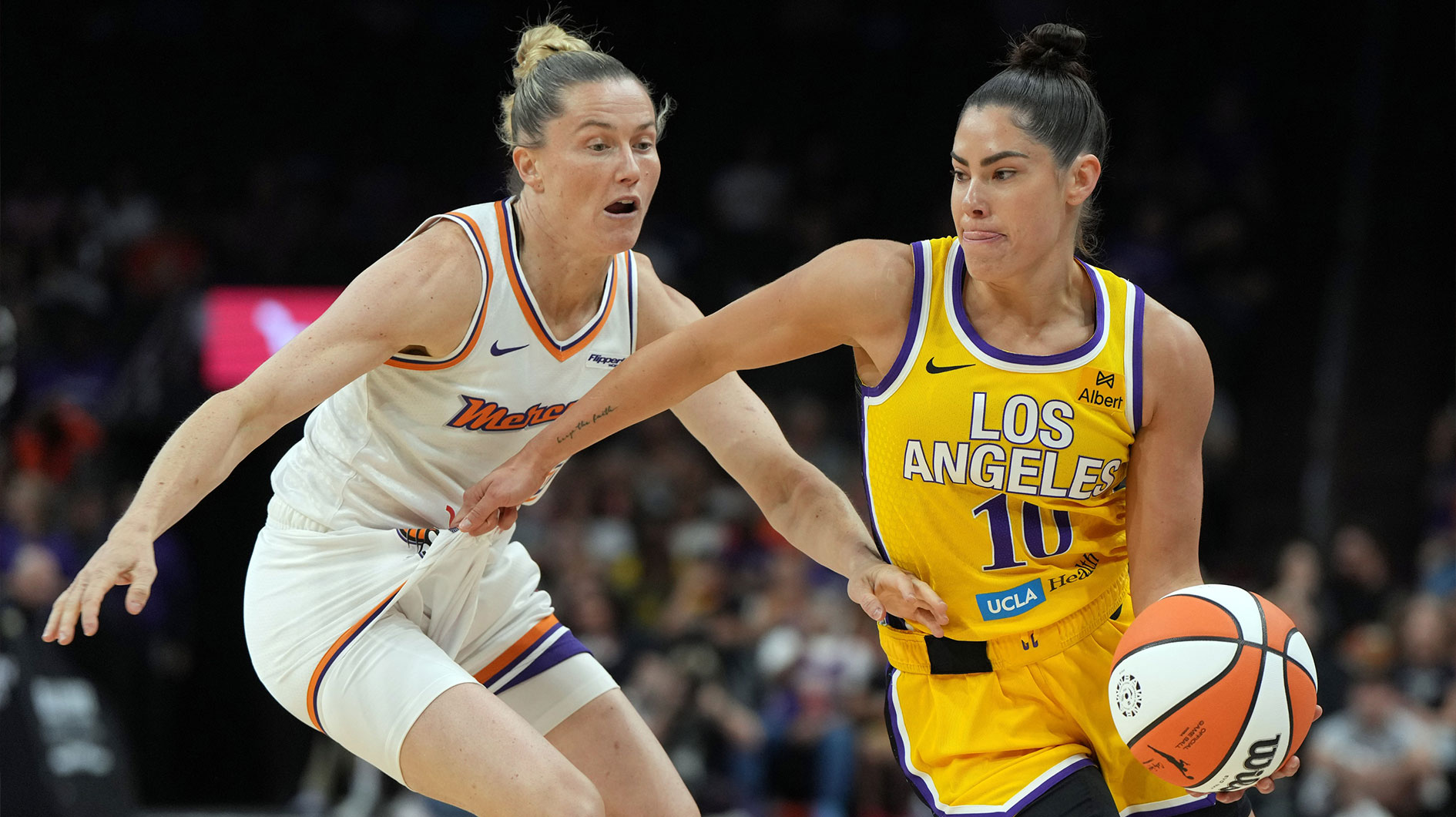 Los Angeles Sparks guard Kelsey Plum (10) drives past Phoenix Mercury guard Sami Whitcomb (33) in the first half at Footprint Center.