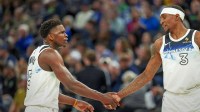 Minnesota Timberwolves guard Anthony Edwards (5) shakes hands with forward Jaden McDaniels (3) after making a shot against the San Antonio Spurs in the first half at Target Center.