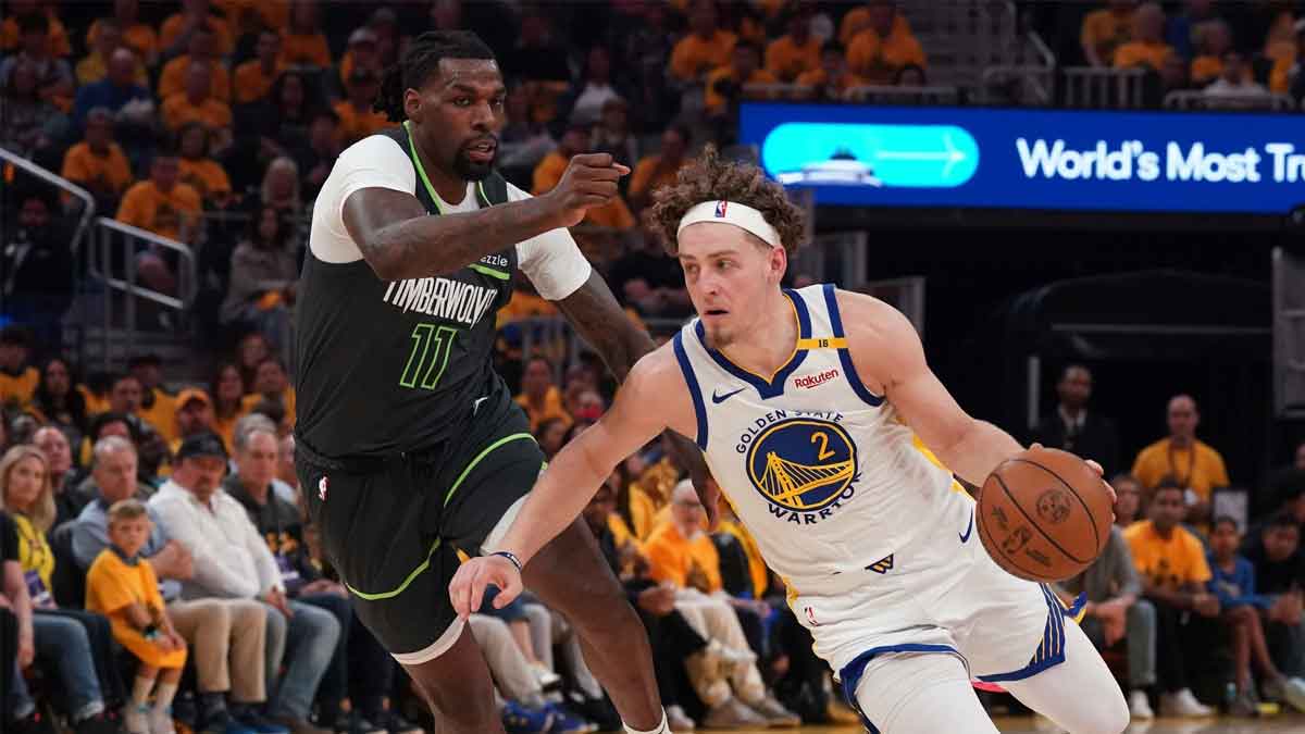 Golden State Warriors guard Brandin Podziemski (2) dribbles past Minnesota Timberwolves center-forward Naz Reid (11) in the second quarter during game three in the second round of the 2025 NBA Playoffs at Chase Center.