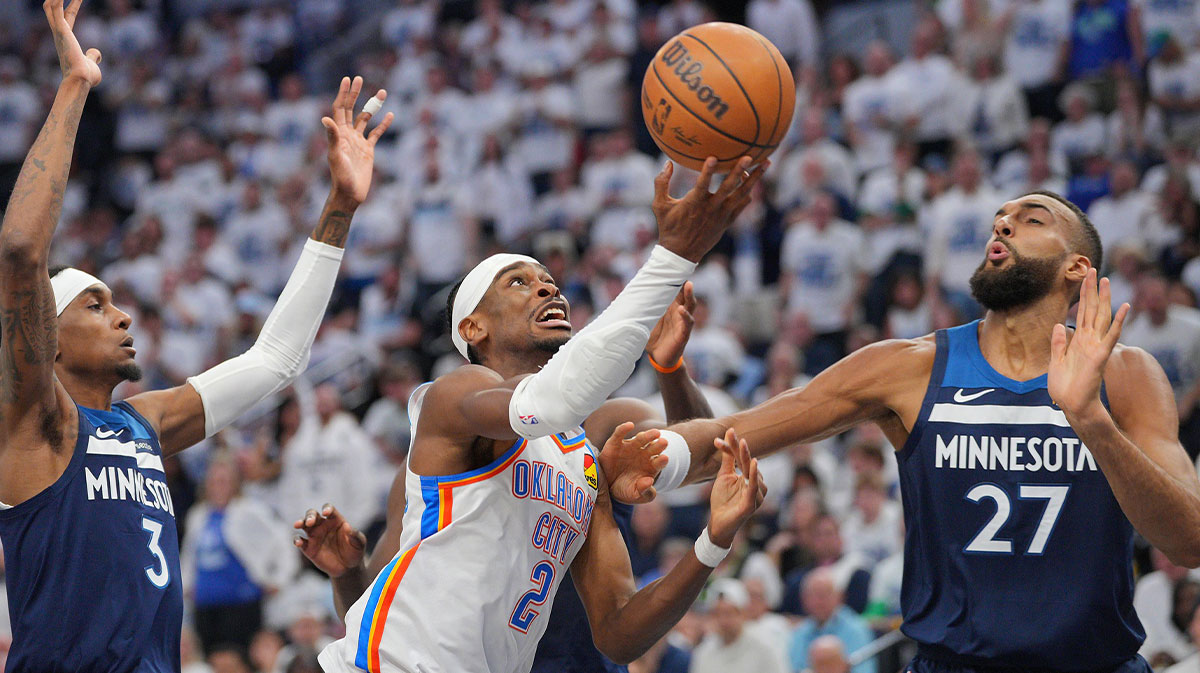 Oklahoma City Thunder guard Shai Gilgeous-Alexander (2) shoots the ball over Minnesota Timberwolves center Rudy Gobert (27) during the first half in game three of the western conference finals for the 2025 NBA Playoffs at Target Center.