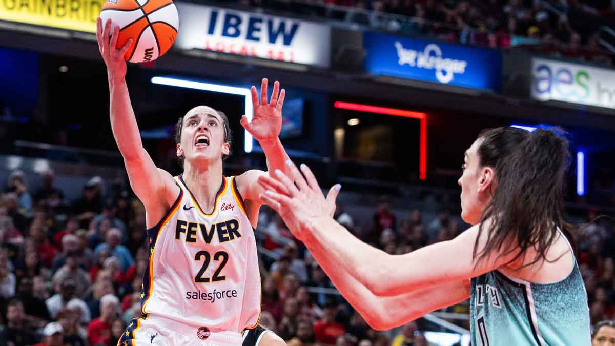 Indiana Fever guard Caitlin Clark (22) shoots the ball while New York Liberty forward Breanna Stewart (30) defends in the second half at Gainbridge Fieldhouse.
