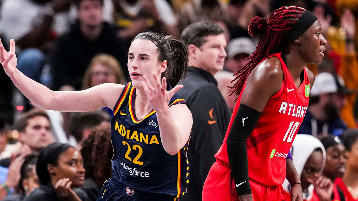 Indiana Fever guard Caitlin Clark (22) reacts after scoring a 3-pointer against Atlanta Dream guard Rhyne Howard (10) uring a game between the Indiana Fever and the Atlanta Dream at Gainbridge Fieldhouse.
