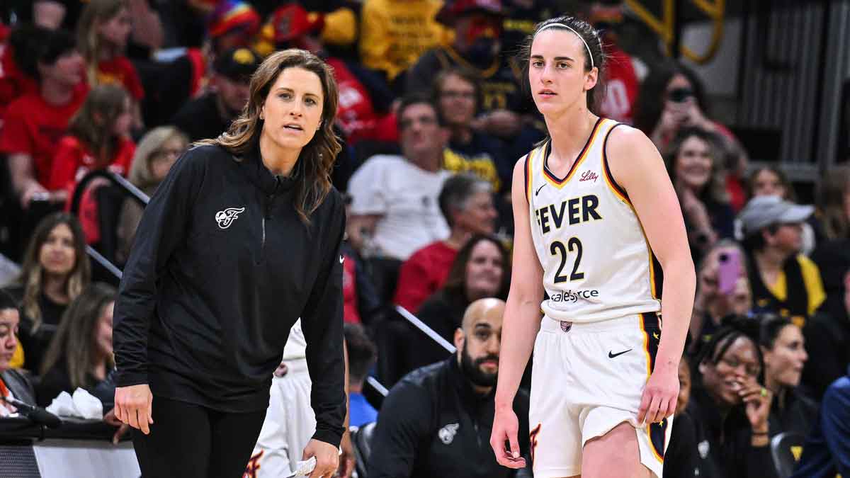 Indiana Fever guard Caitlin Clark (22) looks on with head coach Stephanie White during the third quarter against the Brazil National Team at Carver-Haweye Arena.