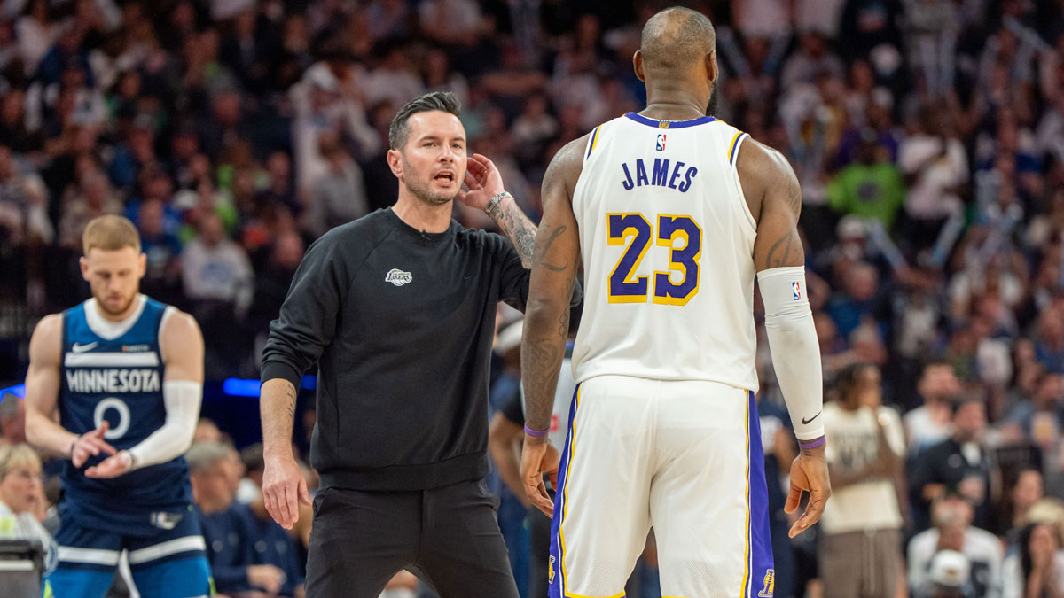 Los Angeles Lakers head coach JJ Redick talks with striker Lebron James (23) at the fourth quarter against the Minnesota Timberwolves during the fourth round of the first round for the NBA 2025 qualifiers at the Target Center.
