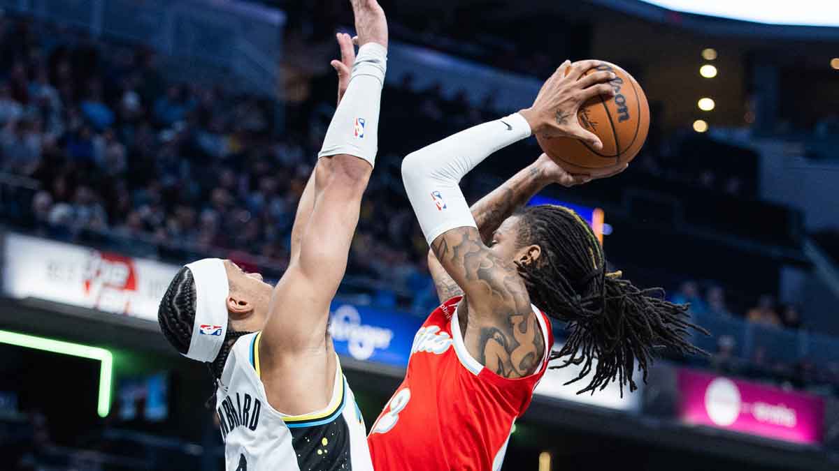 Memphis Grizzlies guard Ja Morant (12) shoots the ball while Indiana Pacers guard Andrew Nembhard (2) defends in the first half at Gainbridge Fieldhouse.
