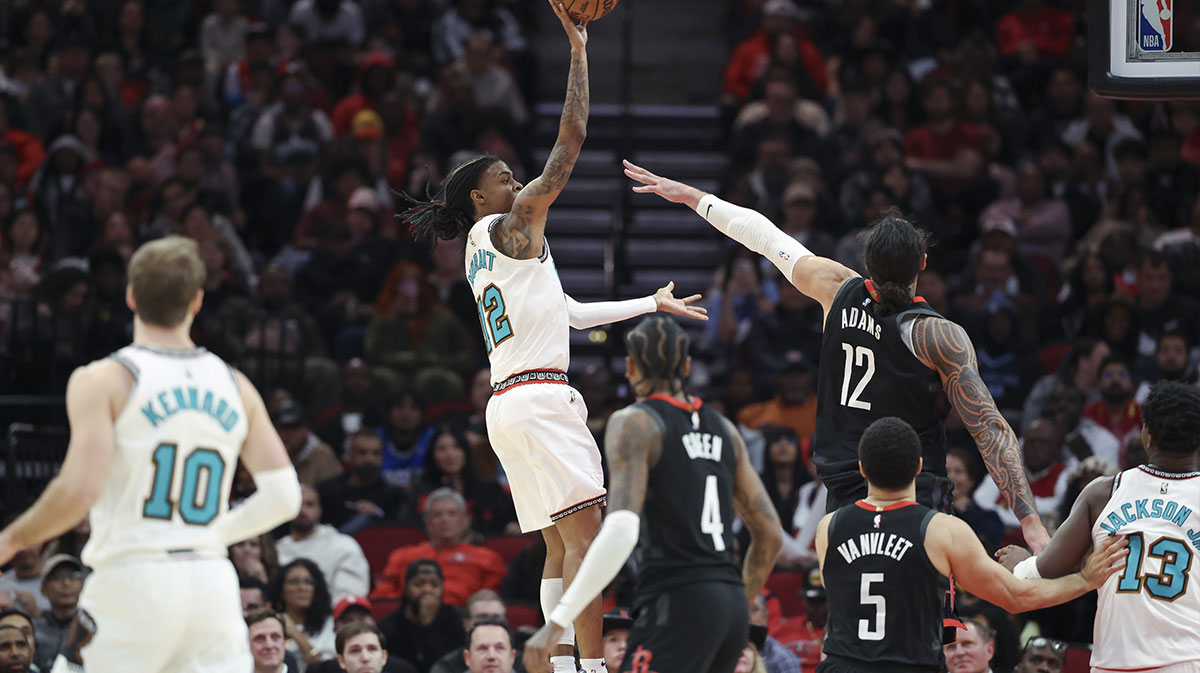 Memphis Grizzlies guard Ja Morant (12) shoots the ball as Houston Rockets center Steven Adams (12) defends during the second half at Toyota Center.