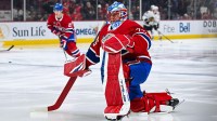 Montreal Canadiens goalie Jakub Dobes (75) kneels on the ice in warm-up before the game against the Chicago Blackhawks at Bell Centre.