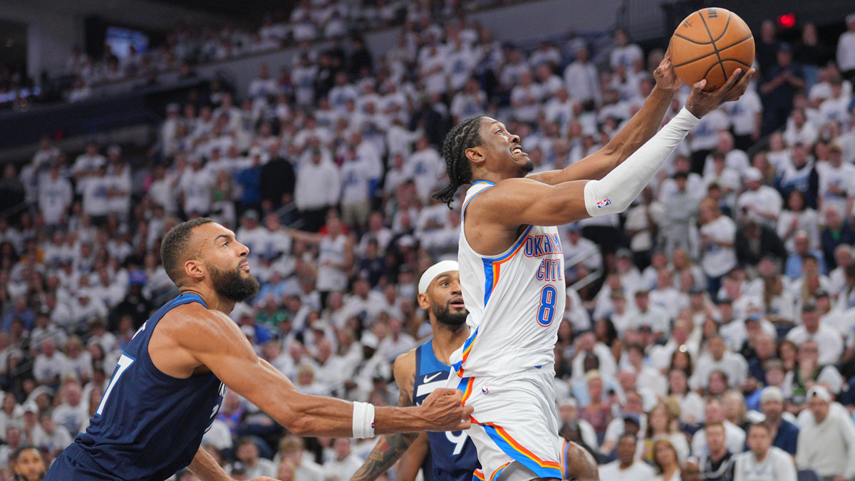 Oklahoma City Thunder forward Jalen Williams (8) dribbles the ball past Minnesota Timberwolves center Rudy Gobert (27) during the first half in game three of the western conference finals for the 2025 NBA Playoffs at Target Center.