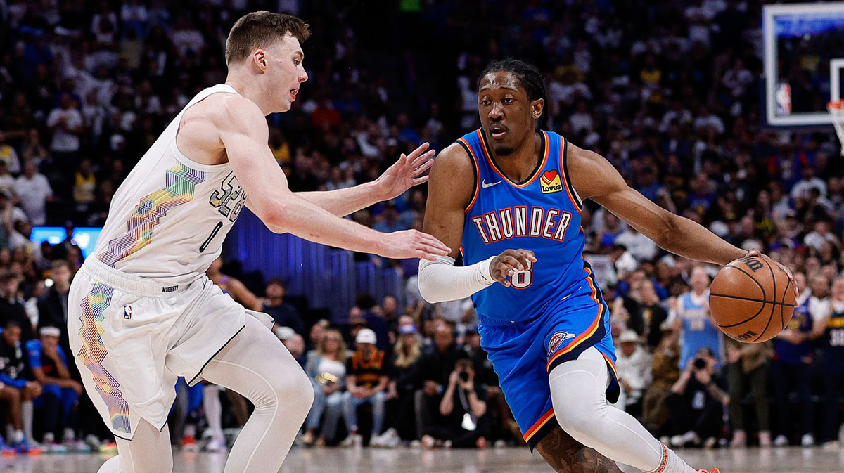 Oklahoma City Thunder forward Jalen Williams (8) controls the ball as Denver Nuggets guard Christian Braun (0) guards in the second quarter during game six of the second round for the 2025 NBA Playoffs at Ball Arena.