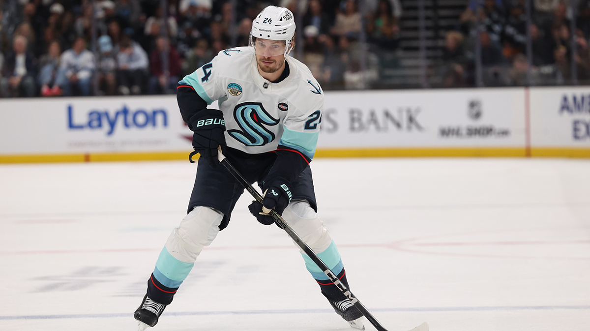 Seattle Kraken defenseman Jamie Oleksiak (24) skates with the puck against the Utah Hockey Club during the first period at Delta Center.