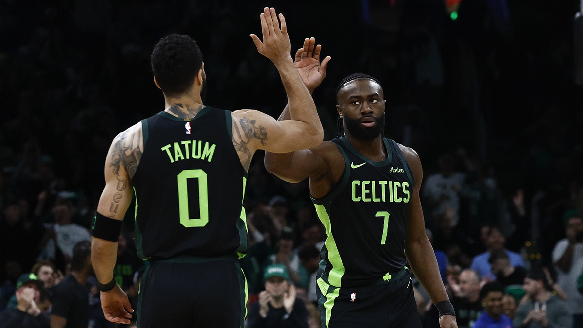 Boston Celtics guard Jaylen Brown (7) high fives forward Jayson Tatum (0) after the Cleveland Cavaliers called a timeout during the first quarter at TD Garden.