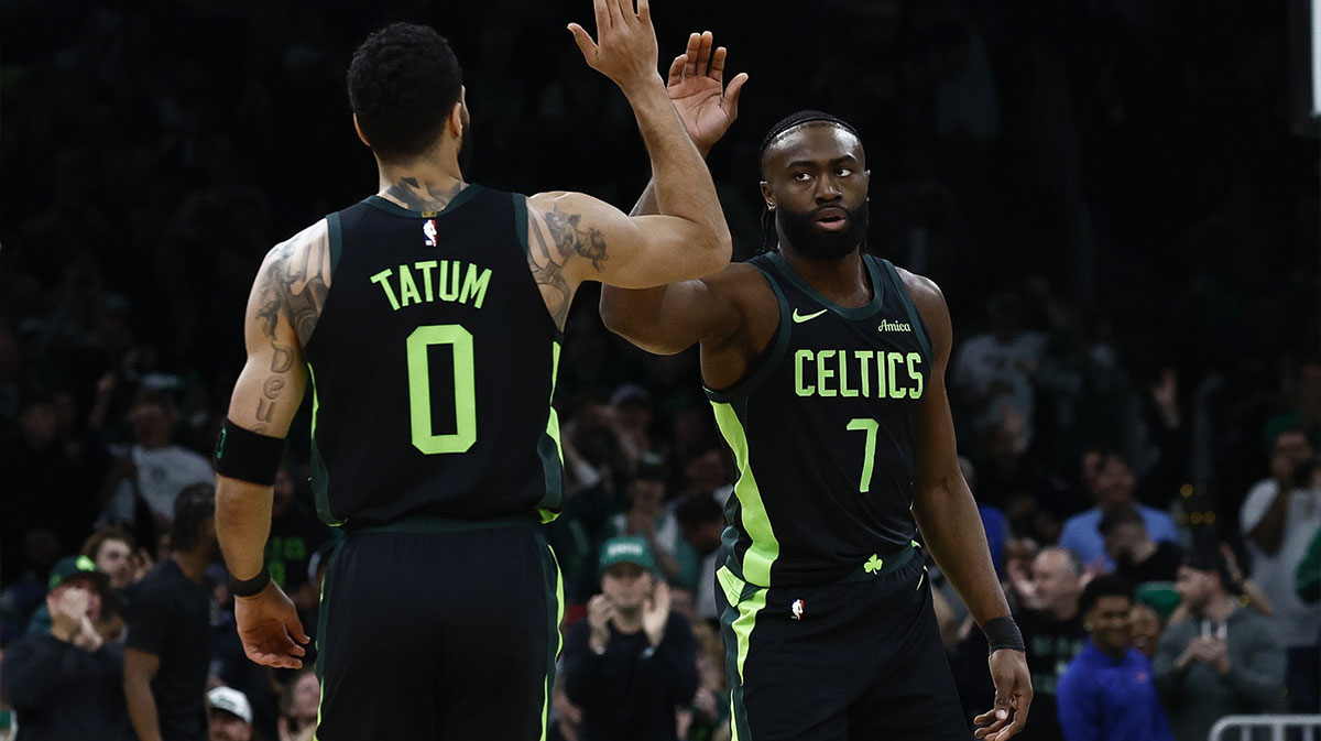 Boston Celtics guard Jaylen Brown (7) high fives forward Jayson Tatum (0) after the Cleveland Cavaliers called a timeout during the first quarter at TD Garden.