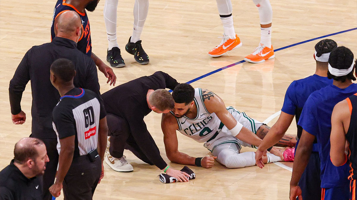 Boston Celtics forward Jayson Tatum (0) with a member of the medical staff on the court after an injury in the second half during game four of the second round for the 2025 NBA Playoffs against the New York Knicks at Madison Square Garden. Tatum would leave the game with an injury after this play.