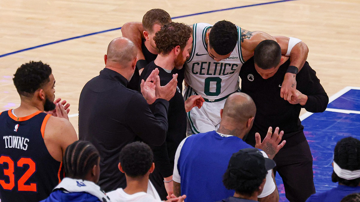 Boston Celtics forward Jayson Tatum (0) is helped off the court by after an injury in the second half during game four of the second round for the 2025 NBA Playoffs against the New York Knicks at Madison Square Garden. Tatum would leave the game with an injury after this play.