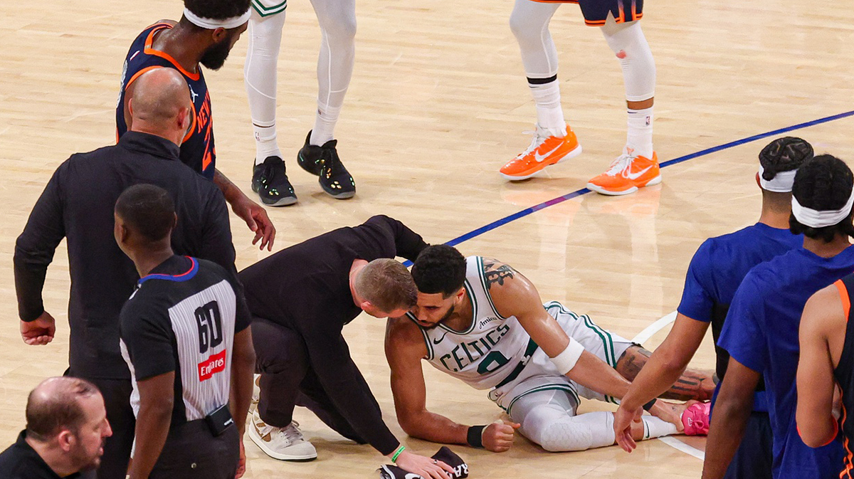 Boston Celtics forward Jayson Tatum (0) with a member of the medical staff on the court after an injury in the second half during game four of the second round for the 2025 NBA Playoffs against the New York Knicks at Madison Square Garden. Tatum would leave the game with an injury after this play.