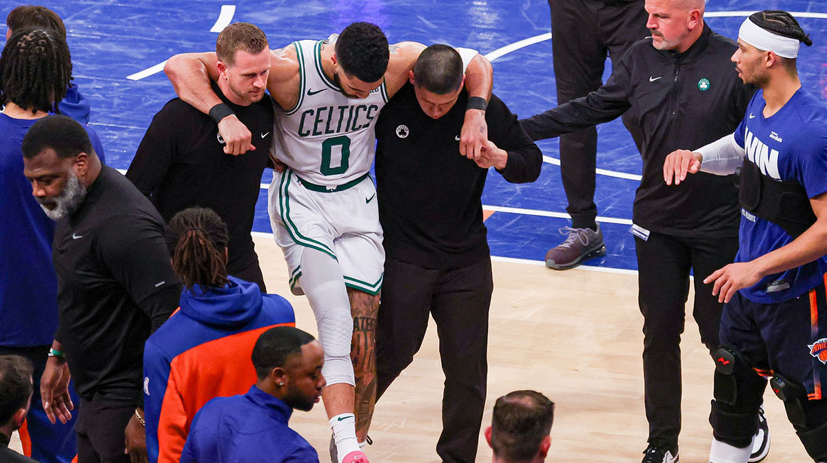 Boston Celtics forward Jayson Tatum (0) is helped off the court by after an injury in the second half during game four of the second round for the 2025 NBA Playoffs against the New York Knicks at Madison Square Garden. Tatum would leave the game with an injury after this play.