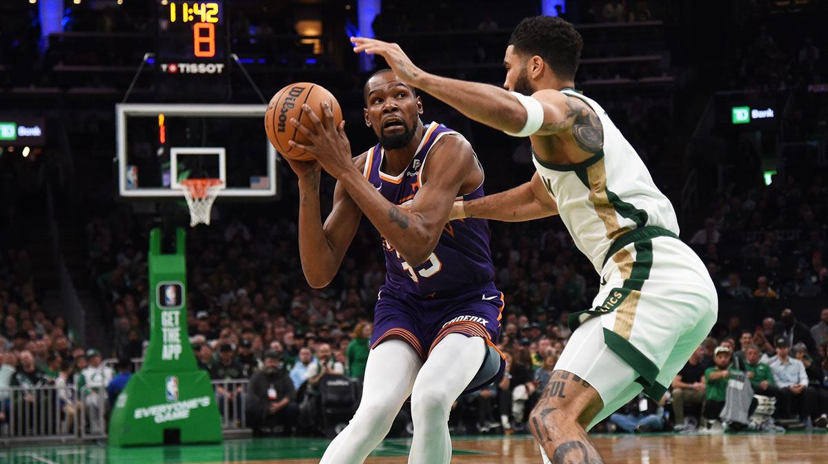 Phoenix Suns forward Kevin Durant (35) controls the ball while Boston Celtics forward Jayson Tatum (0) defends during the first half at TD Garden.