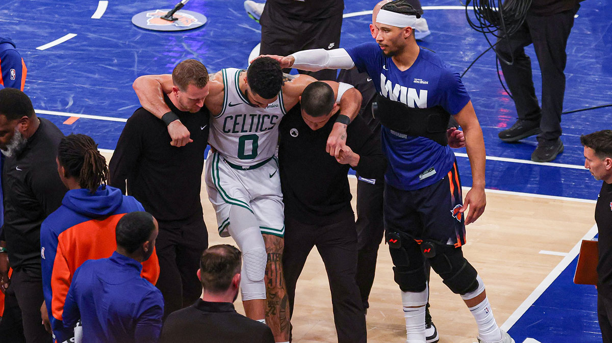 Boston Celtics forward Jayson Tatum (0) is helped off the court by after an injury in the second half during game four of the second round for the 2025 NBA Playoffs as New York Knicks guard Josh Hart (3) gestures at Madison Square Garden. Tatum would leave the game with an injury after this play.