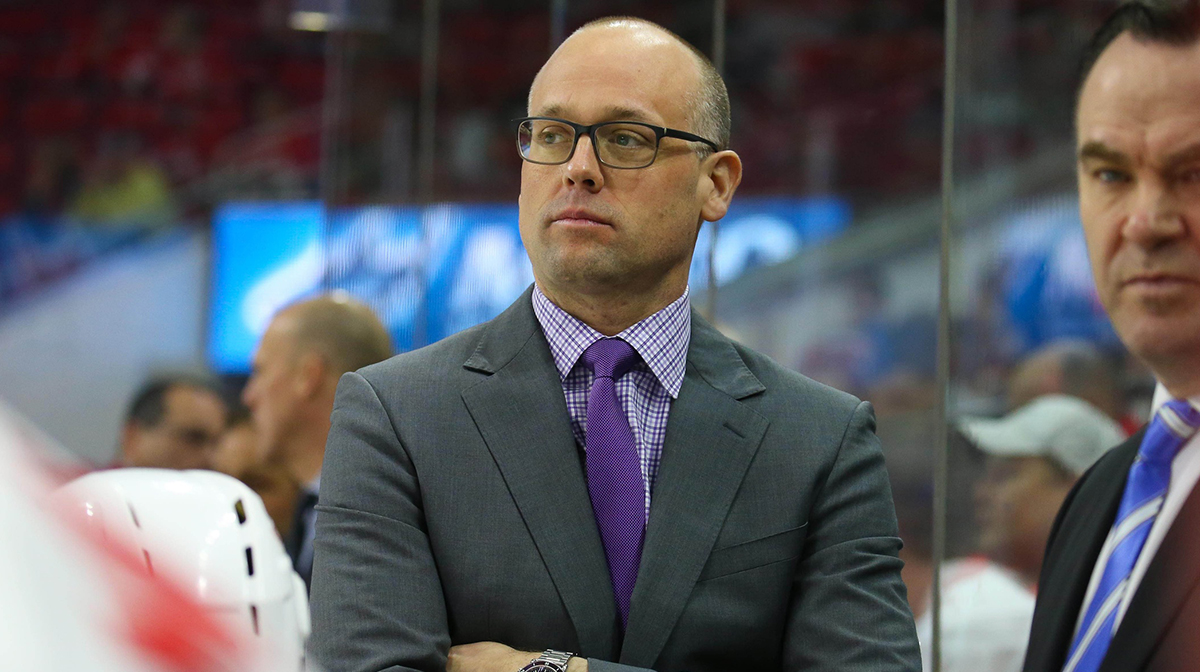 Detroit Red Wings head coach Jeff Blashill looks on form behind the bench against the Carolina Hurricanes at PNC Arena. The Detroit Red Wings defeated the Carolina Hurricanes 4-3 in overtime.