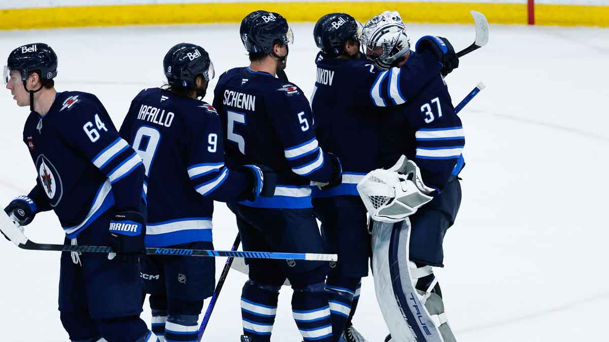 Winnipeg Jets goalie Connor Hellebuyck (37) is congratulated by Winnipeg Jets forward Vladislav Namestnikov (7) on his win against the St. Louis Blues during the third period in game five of the first round of the 2025 Stanley Cup Playoffs at Canada Life Centre.