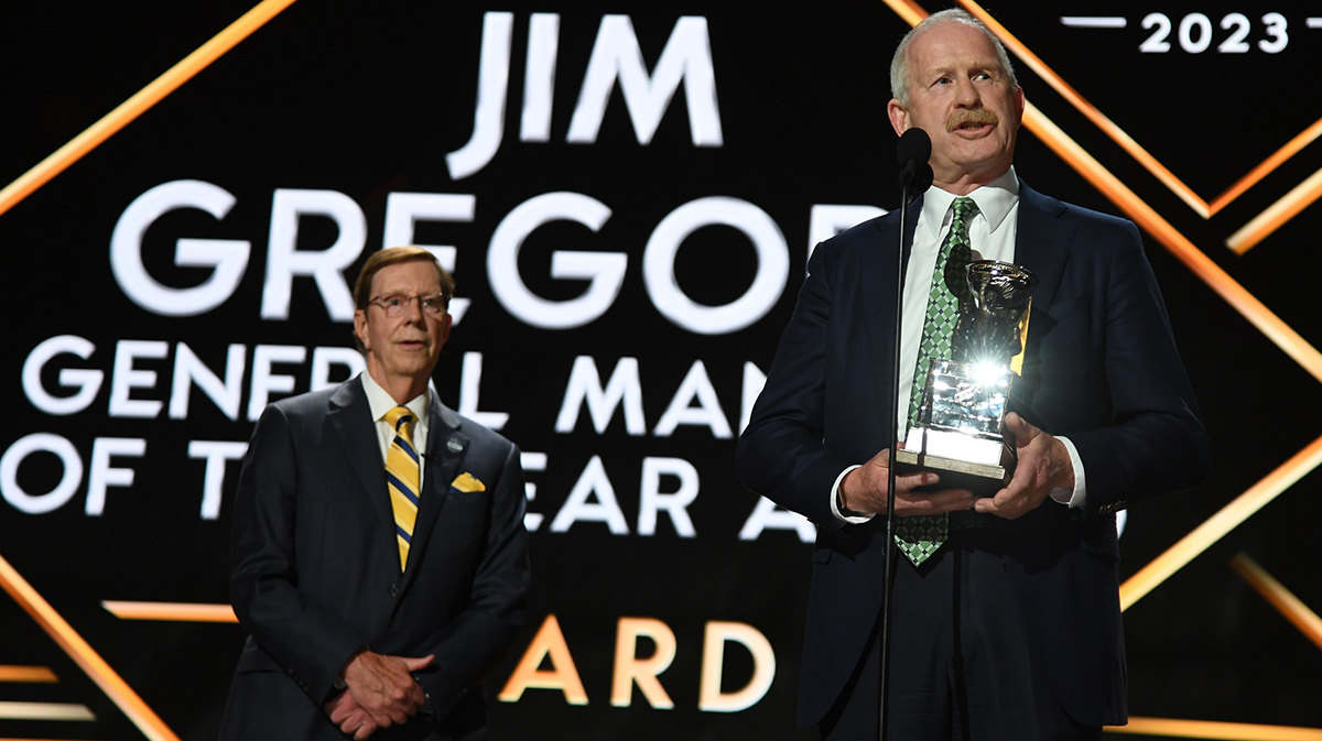 Dallas Stars general manager Jim Nill is awarded the Jim Gregory General Manager of the Year award by Nashville Predators general manager David Poile during the first round of the 2023 NHL Draft at Bridgestone Arena.