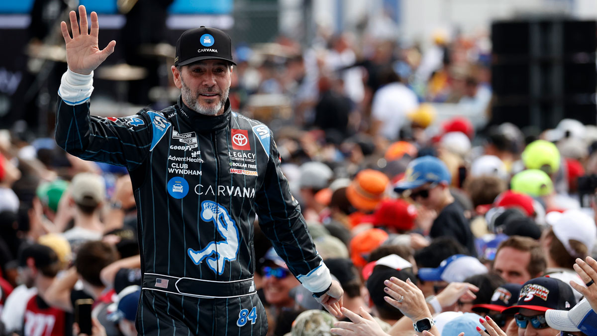 Feb 16, 2025; Daytona Beach, Florida, USA; NASCAR Cup Series driver Jimmie Johnson (84) walks onto the driver introduction stage to greet fans before the Daytona 500 at Daytona International Speedway. Mandatory Credit: Peter Casey-Imagn Images