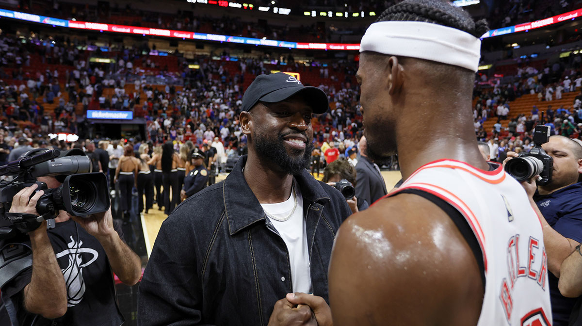 Former Miami Heat player Dwyane Wade talks to Miami Heat forward Jimmy Butler (22) after the game against the New York Knicks at Miami-Dade Arena.