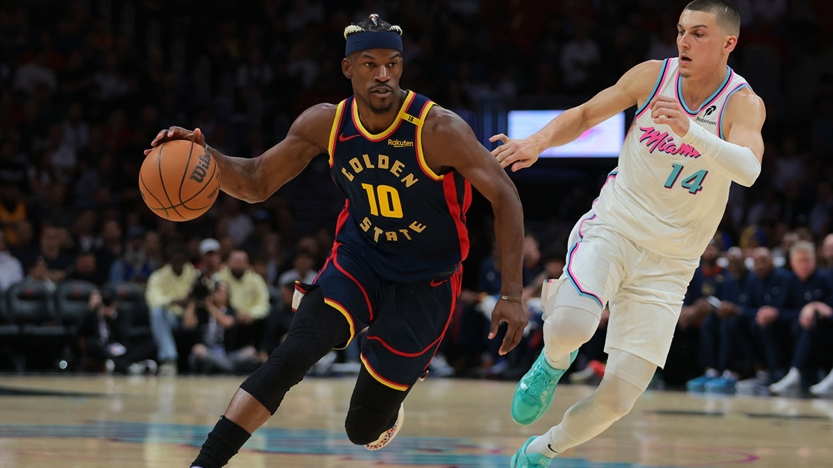 Golden State Warriors forward Jimmy Butler III (10) drives to the basket past Miami Heat guard Tyler Herro (14) during the first quarter at Kaseya Center.