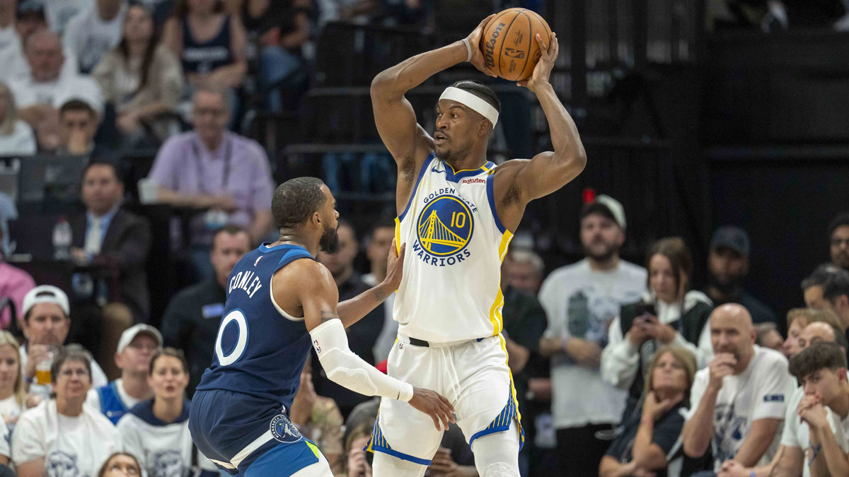 Golden State Warriors forward Jimmy Butler III (10) holds the ball over his head as Minnesota Timberwolves guard Mike Conley (10) plays degrees in the first half during game five of the second round for the 2025 NBA Playoffs at Target Center.