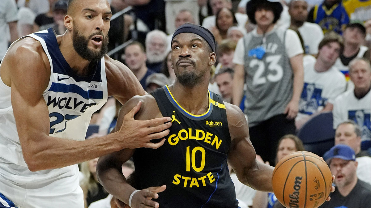 Golden State Warriors forward Jimmy Butler (10) goes to the basket against Minnesota Timberwolves center Rudy Gobert (27) in the fourth quarter during game one of the second round for the 2025 NBA Playoffs at Target Center.