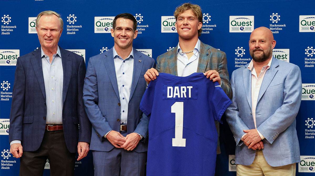 New York Giants president John Mara (far left), general manager Joe Schoen (left), Jaxson Dart, and head coach Brian Daboll (right) pose for photos prior to the start of the press conference to introduce the Giants first round draft picks