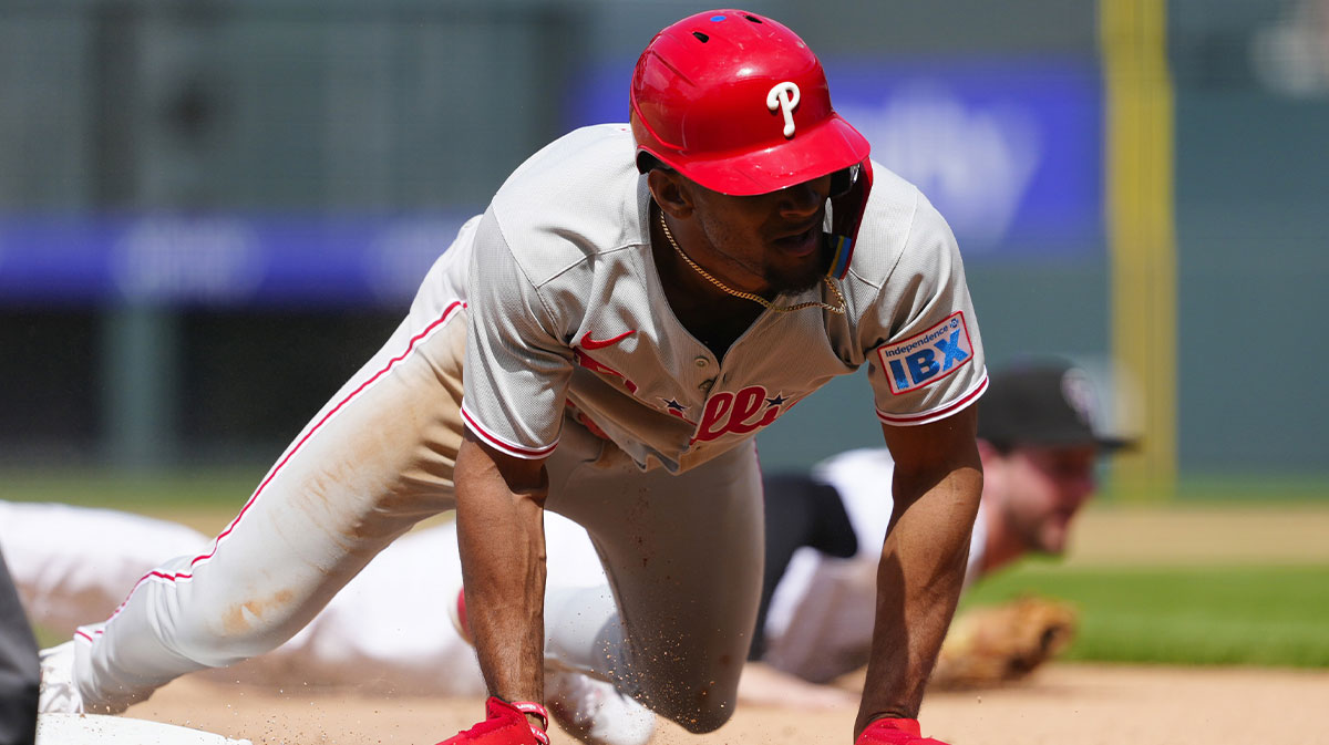 Philadelphia Phillies pinch runner Johan Rojas (23) takes third on a throwing error in the ninth inning against the Colorado Rockies at Coors Field.