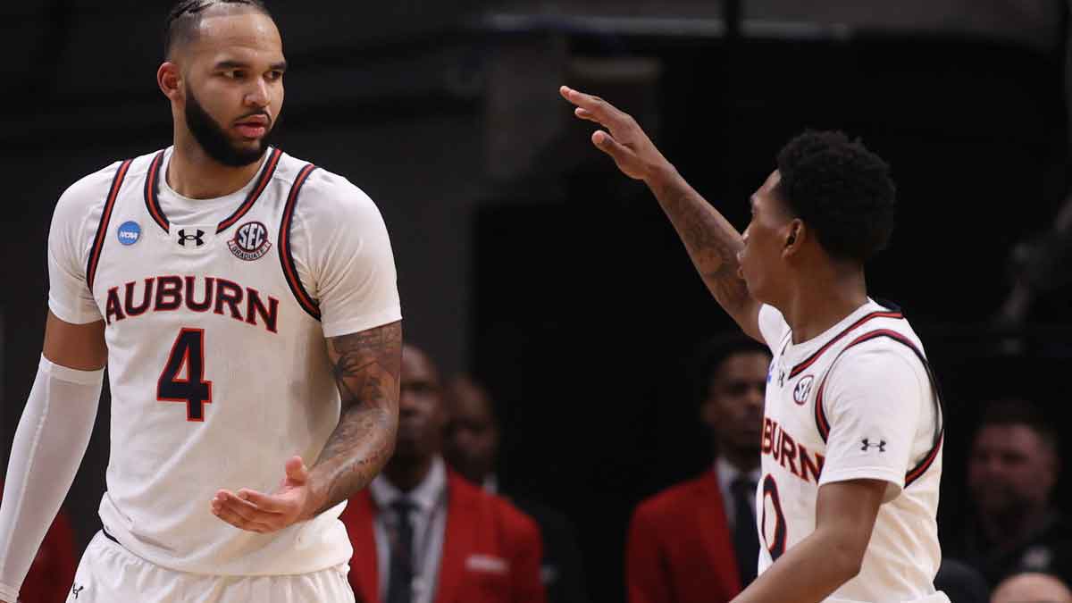 Auburn Tigers forward Johni Broome (4) celebrates with guard Tahaad Pettiford (0) in the second half of a South Regional semifinal of the 2025 NCAA tournament against the Michigan Wolverines at State Farm Arena.