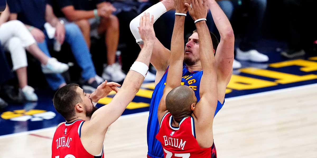 LA Clippers center Ivica Zubac (40) and forward Nicolas Batum (33) defend on Denver Nuggets center Nikola Jokic (15) in the first half during game seven of first round for the 2025 NBA Playoffs at Ball Arena. Mandatory Credit: Ron Chenoy-Imagn Images