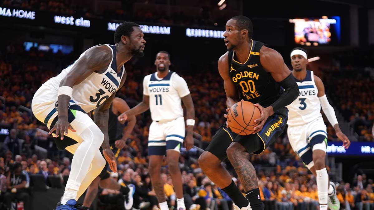 Golden State Warriors forward Jonathan Kuminga (00) holds onto the ball next to Minnesota Timberwolves forward Julius Randle (30) in the third quarter during game four of the second round for the 2025 NBA Playoffs at Chase Center.