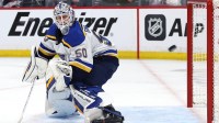 St. Louis Blues goaltender Jordan Binnington (50) eyes the puck against the Winnipeg Jets in the second period in game seven of the first round of the 2025 Stanley Cup Playoffs at Canada Life Centre.