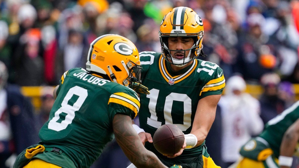 Green Bay Packers quarterback Jordan Love (10) hands the football off to running back Josh Jacobs (8) during the first quarter against the Chicago Bears at Lambeau Field.