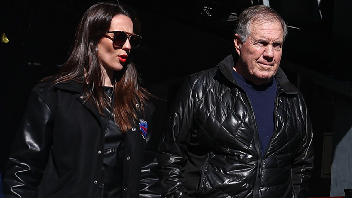Former New England Patriots head coach Bill Belichick and girlfriend Jordon Hudson enter the field before the game between the Notre Dame Fighting Irish and the Navy Midshipmen at MetLife Stadium.