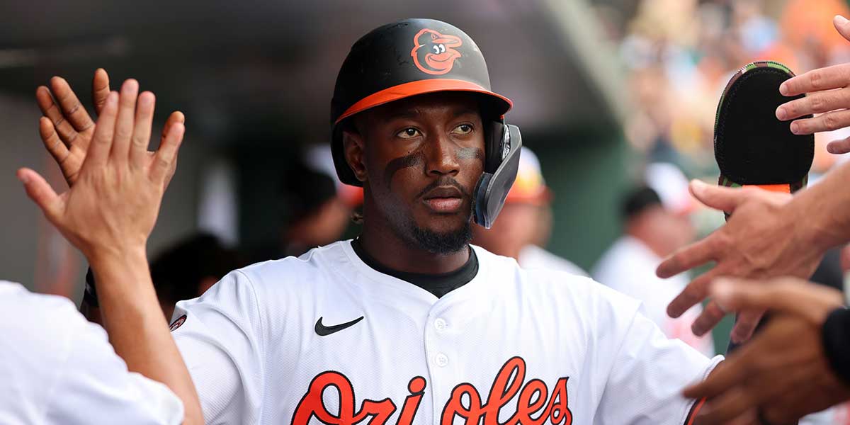 Mar 12, 2024; Sarasota, Florida, USA; Baltimore Orioles shortstop Jorge Mateo (3) is congratulated in the dugout after scoring during the fifth inning against the Tampa Bay Rays at Ed Smith Stadium.