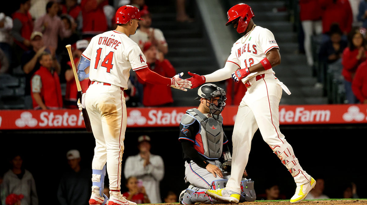 Los Angeles Angels right fielder Jorge Soler (12) is greeted by designated hitter Logan O'Hoppe (14) after hitting a home run during the eighth inning against the Miami Marlins at Angel Stadium.