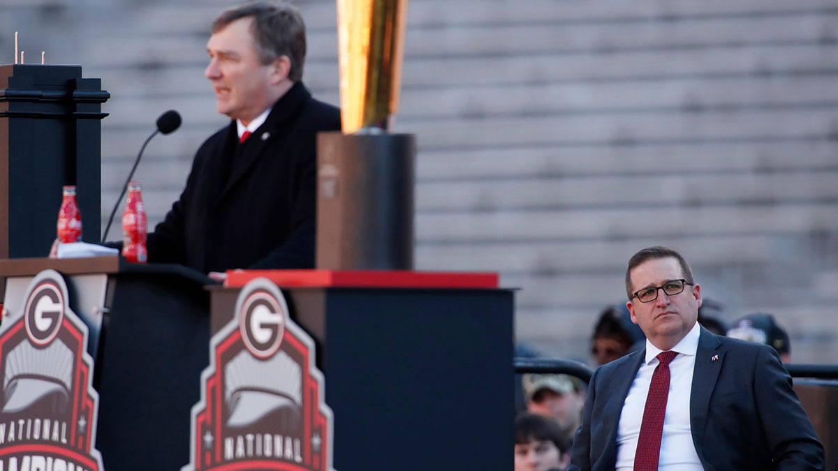 Georgia Athletic Director Josh Brooks looks on while Georgia coach Kirby Smart speaks during Georgia's back to back National Championship celebration