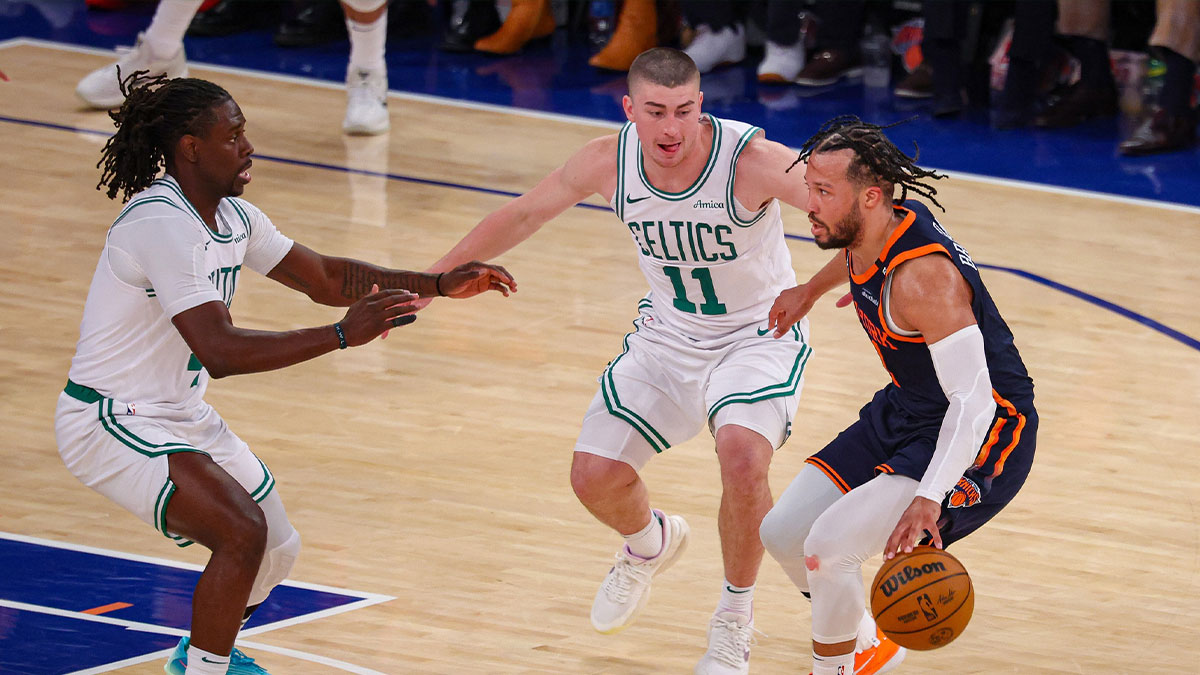 New York Knicks guard Jalen Brunson (11) dribbles against Boston Celtics guard Payton Pritchard (11) and Jrue Holiday (4) in the second half during game four of the second round for the 2025 NBA Playoffs at Madison Square Garden.