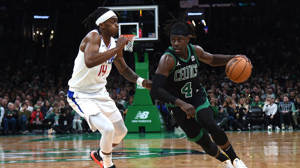 Boston Celtics guard Jrue Holiday (4) controls the ball while LA Clippers guard Terance Mann (14) defends during the second half at TD Garden.