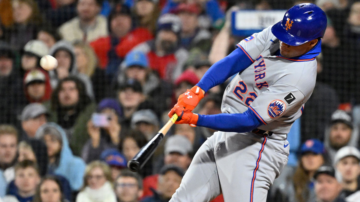 New York Mets right fielder Juan Soto (22) hits a RBI sacrifice fly during the seventh inning against the Boston Red Sox at Fenway Park.
